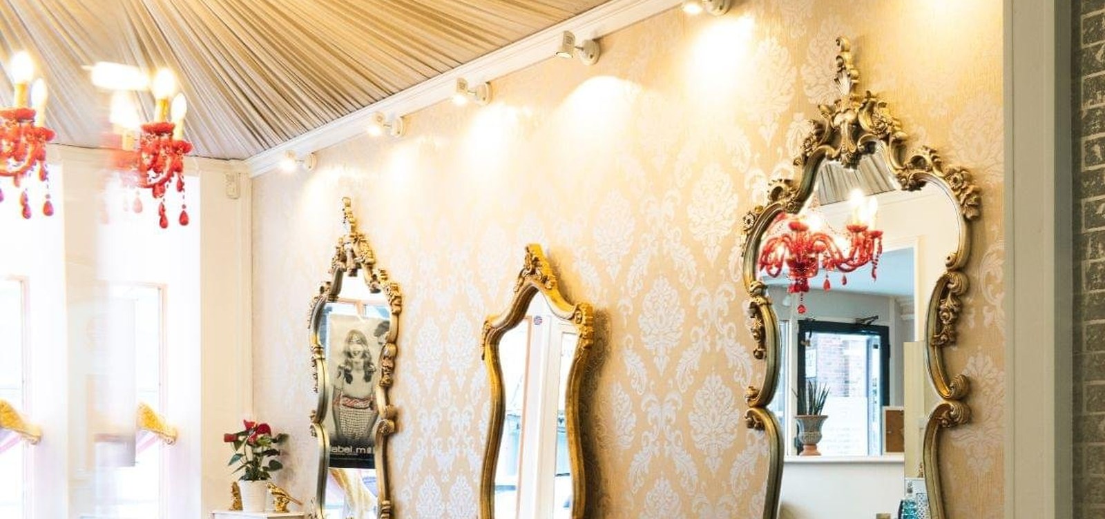 Serenity's award-winning salon — gold mirrors, damask walls and chandeliers